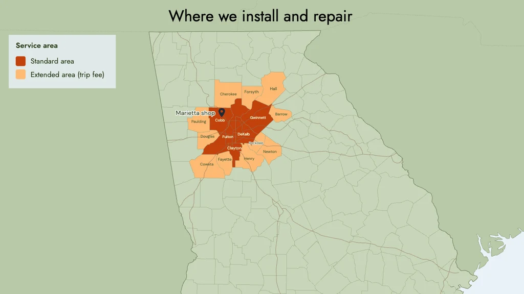 HVAC service area map of metro Atlanta: core Georgia counties in dark orange, surrounding trip-fee counties in light orange and a pin for the shop